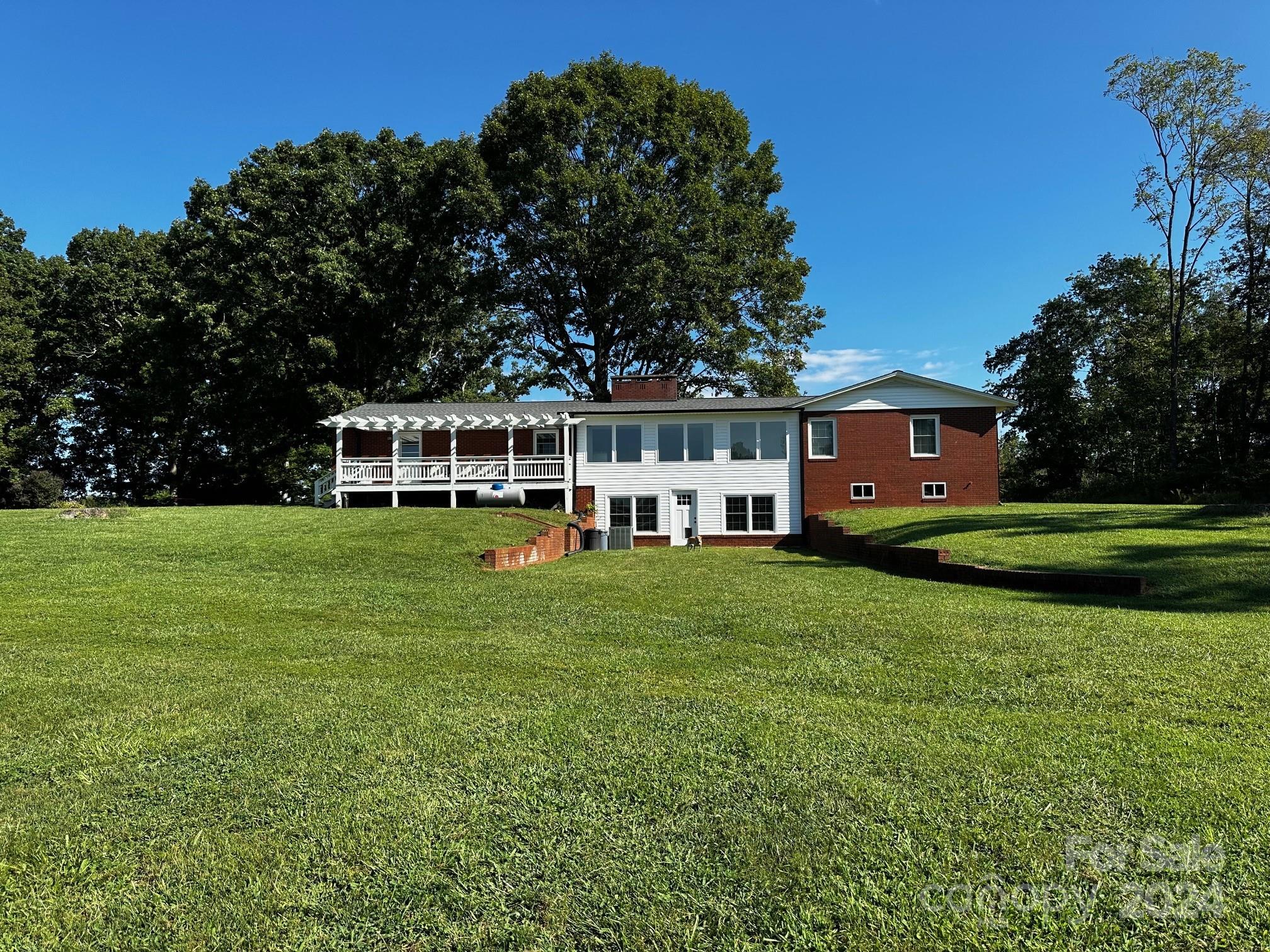 303 Legion Road Hudson, NC 28638 - Photo 22 of 32 a view of a house with a yard