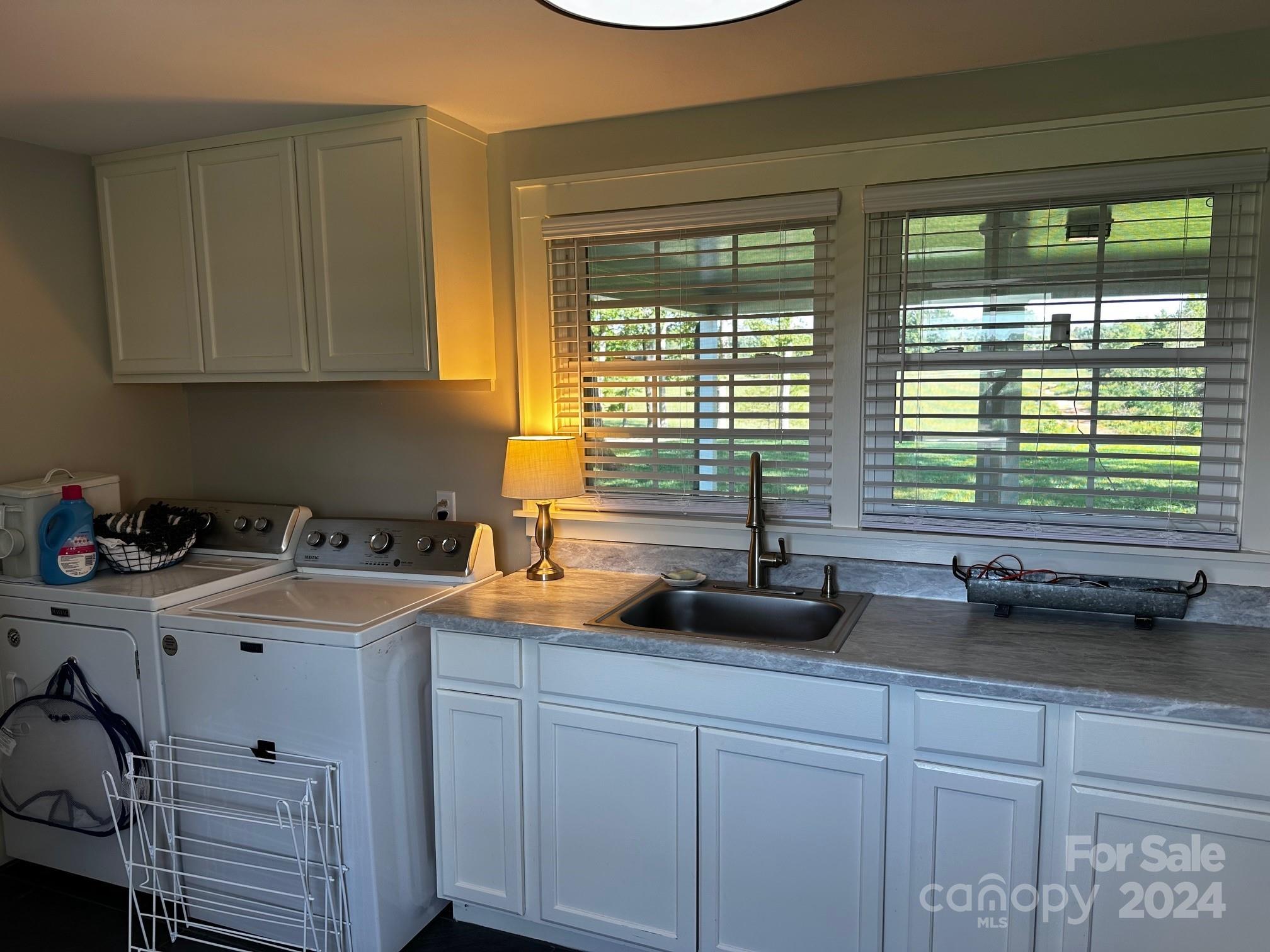 303 Legion Road Hudson, NC 28638 - Photo 27 of 32 a kitchen with a sink a counter and cabinets