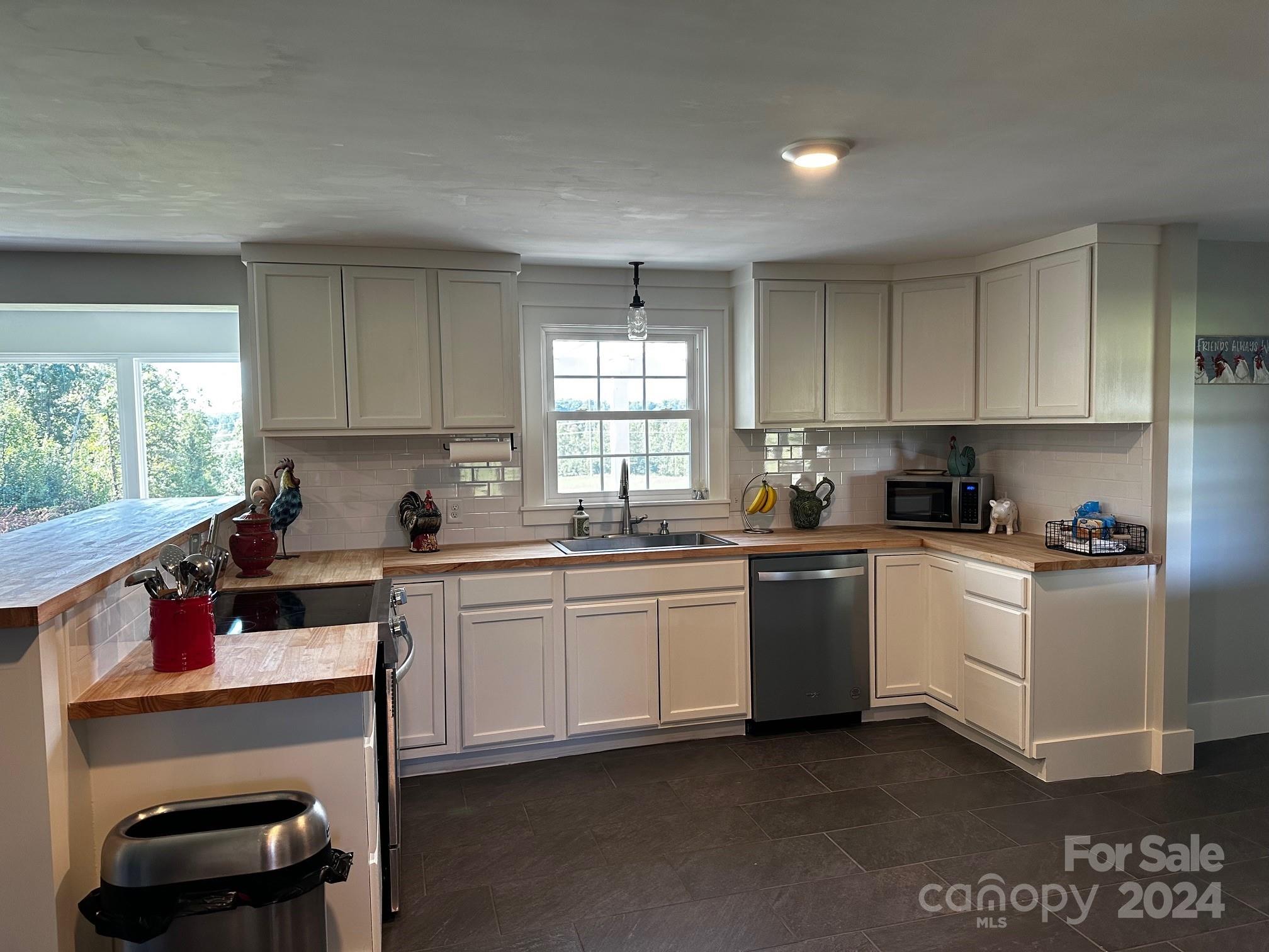 303 Legion Road Hudson, NC 28638 - Photo 5 of 32 a kitchen with a sink cabinets and window