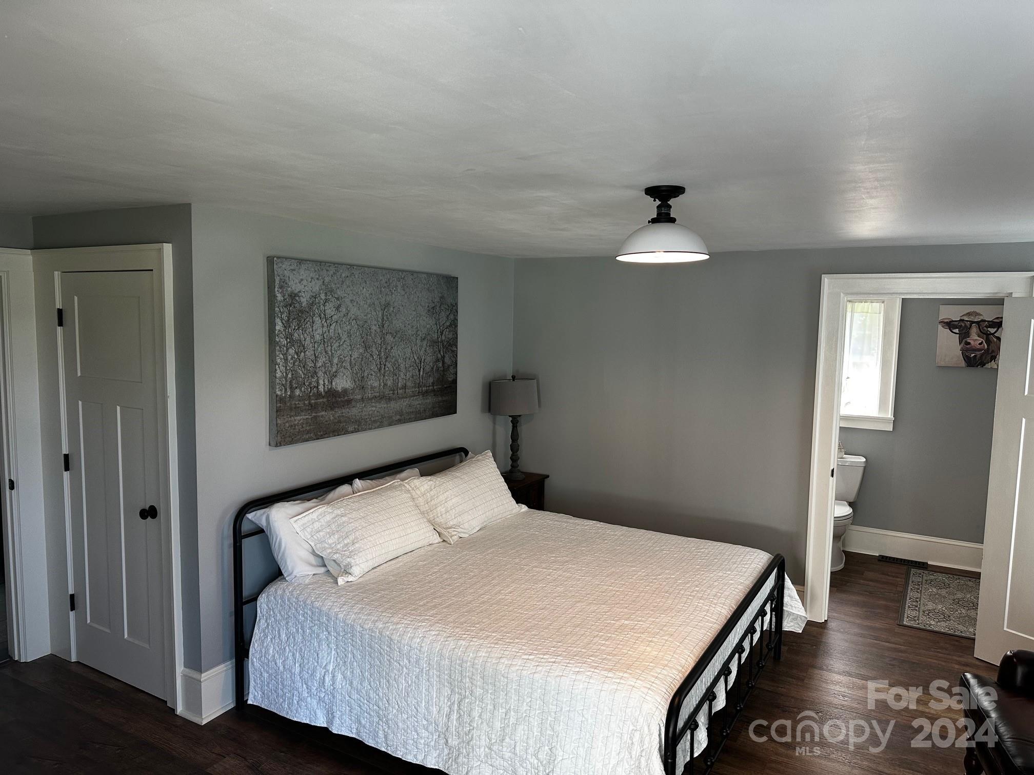303 Legion Road Hudson, NC 28638 - Photo 10 of 32 a bedroom with a bed and a painting on the wall