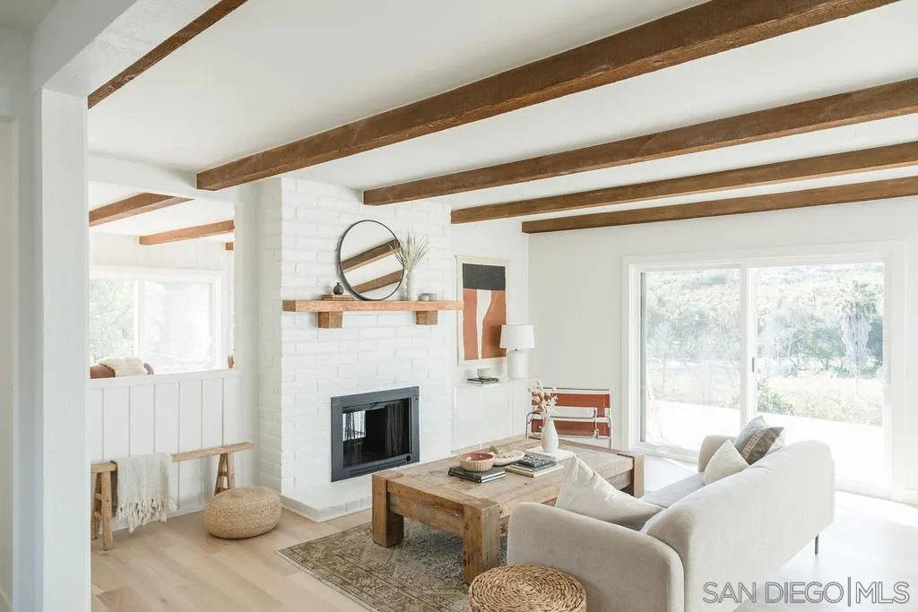180 Spanish Spur Fallbrook, CA 92028 - Photo 9 of 44 a living room with furniture a fireplace and a floor to ceiling window