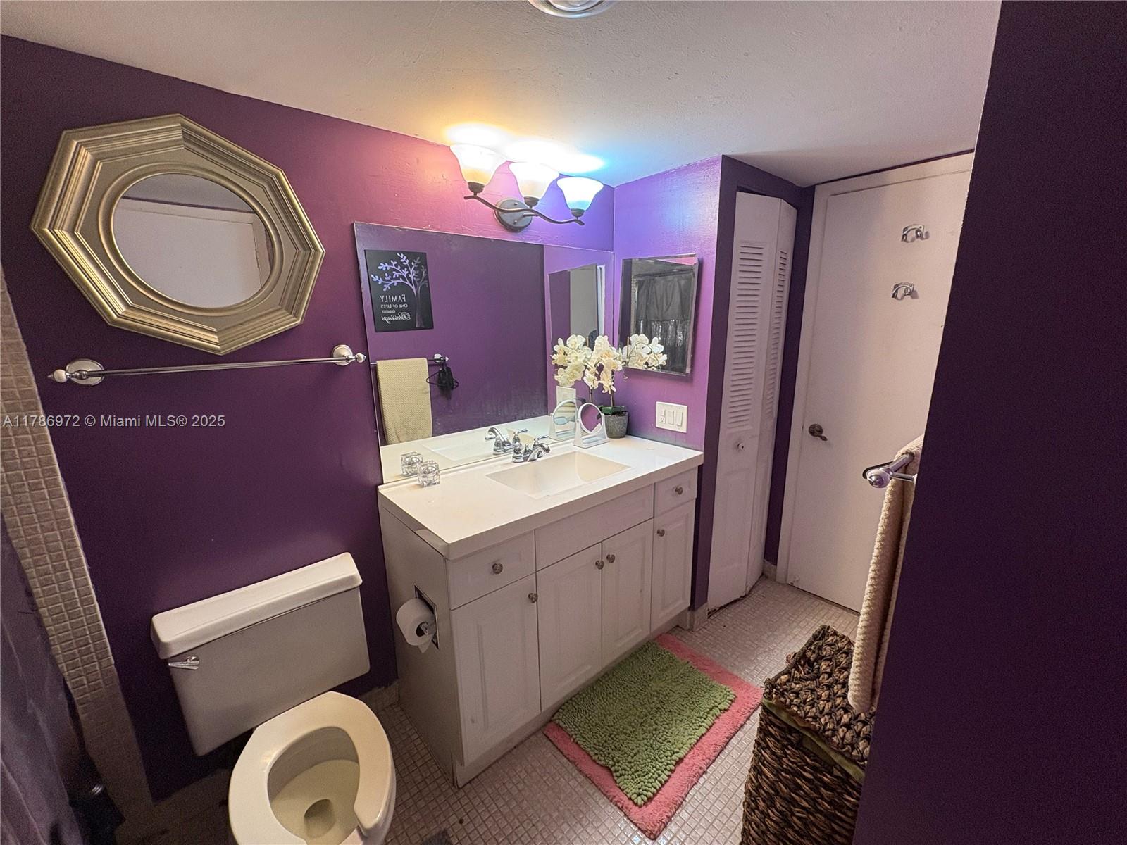 4152 Inverrary Drive, Unit 303 Lauderhill, FL 33319 - Photo 6 of 11 a bathroom with a sink a vanity and a mirror