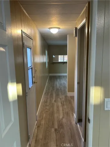 a view of hallway with wooden floor