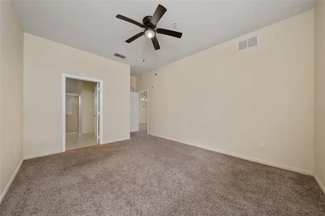a view of a big room with a ceiling fan