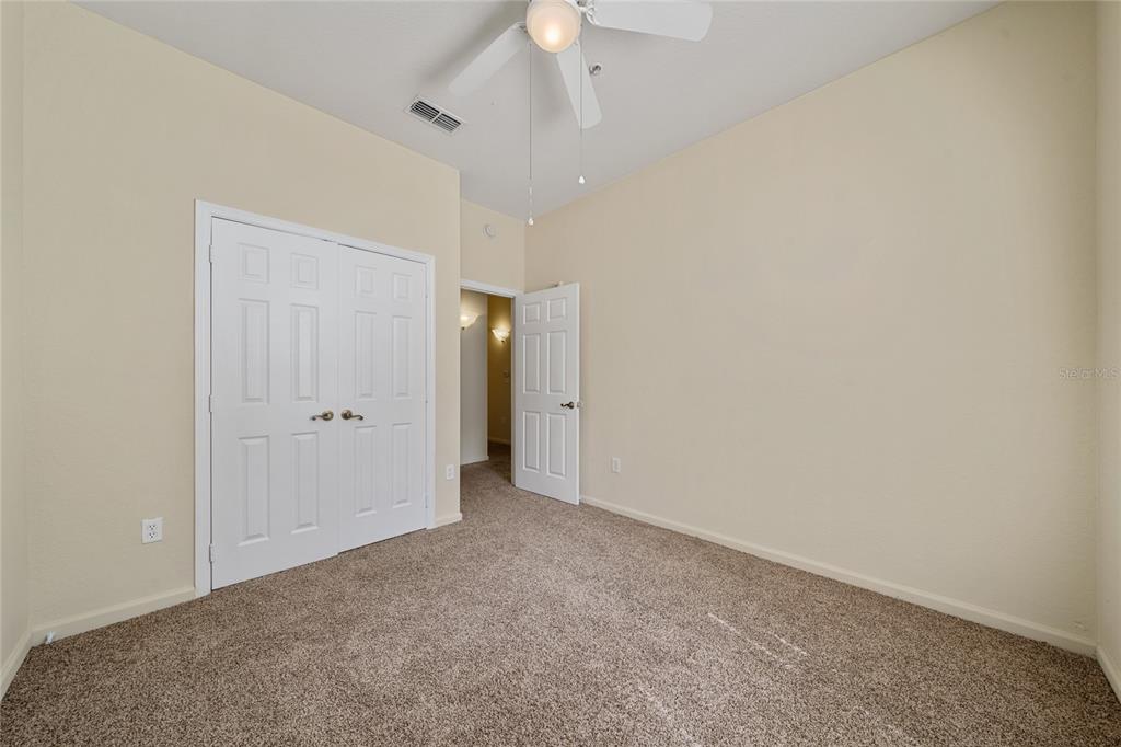 3001 Greystone Loop, Unit 103 Kissimmee, FL 34741 - Photo 20 of 31 a view of an empty room and a ceiling fan