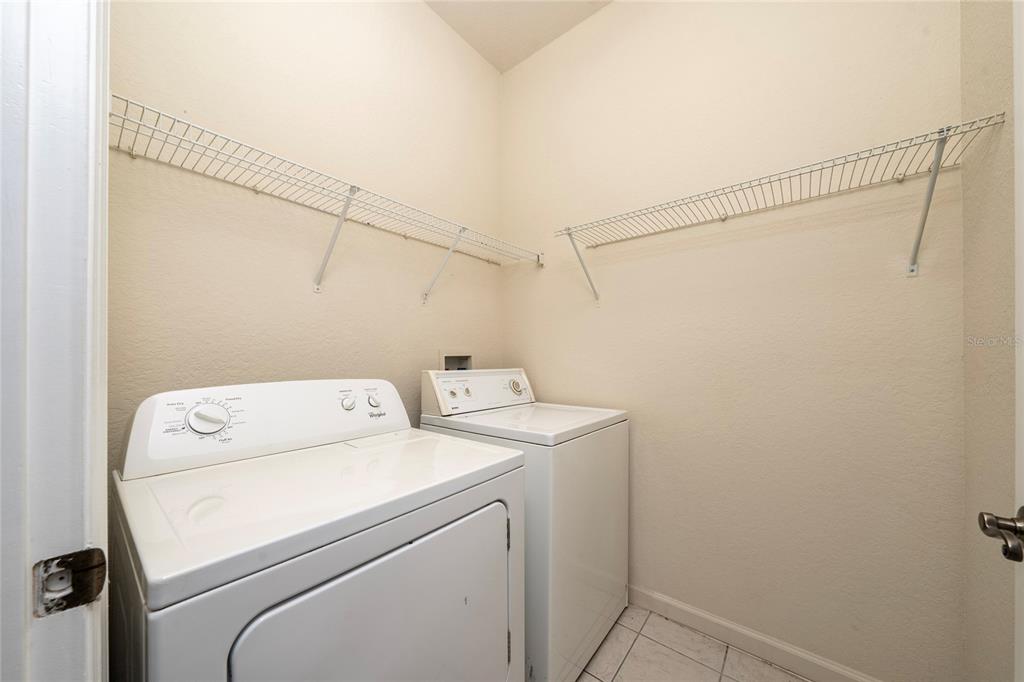 3001 Greystone Loop, Unit 103 Kissimmee, FL 34741 - Photo 24 of 31 a utility room with dryer and washer