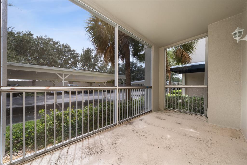 3001 Greystone Loop, Unit 103 Kissimmee, FL 34741 - Photo 25 of 31 a view of balcony with floor to ceiling window and wooden fence