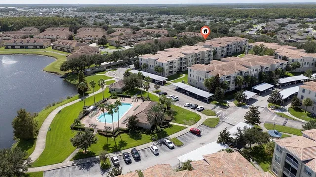 an aerial view of a house with a swimming pool outdoor seating and yard