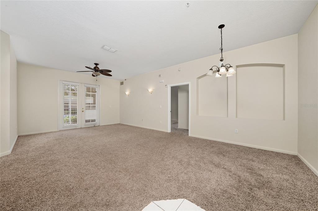 3001 Greystone Loop, Unit 103 Kissimmee, FL 34741 - Photo 8 of 31 a view of an empty room and chandelier fan