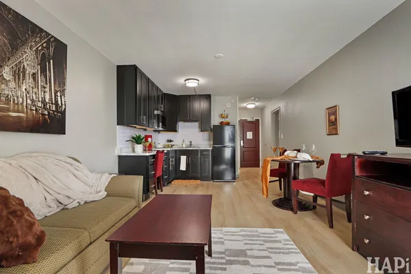 a living room with furniture and kitchen view
