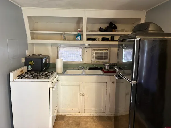 a kitchen with a stove and a refrigerator