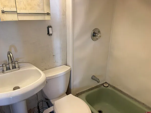 a bathroom with a sink mirror toilet and shower