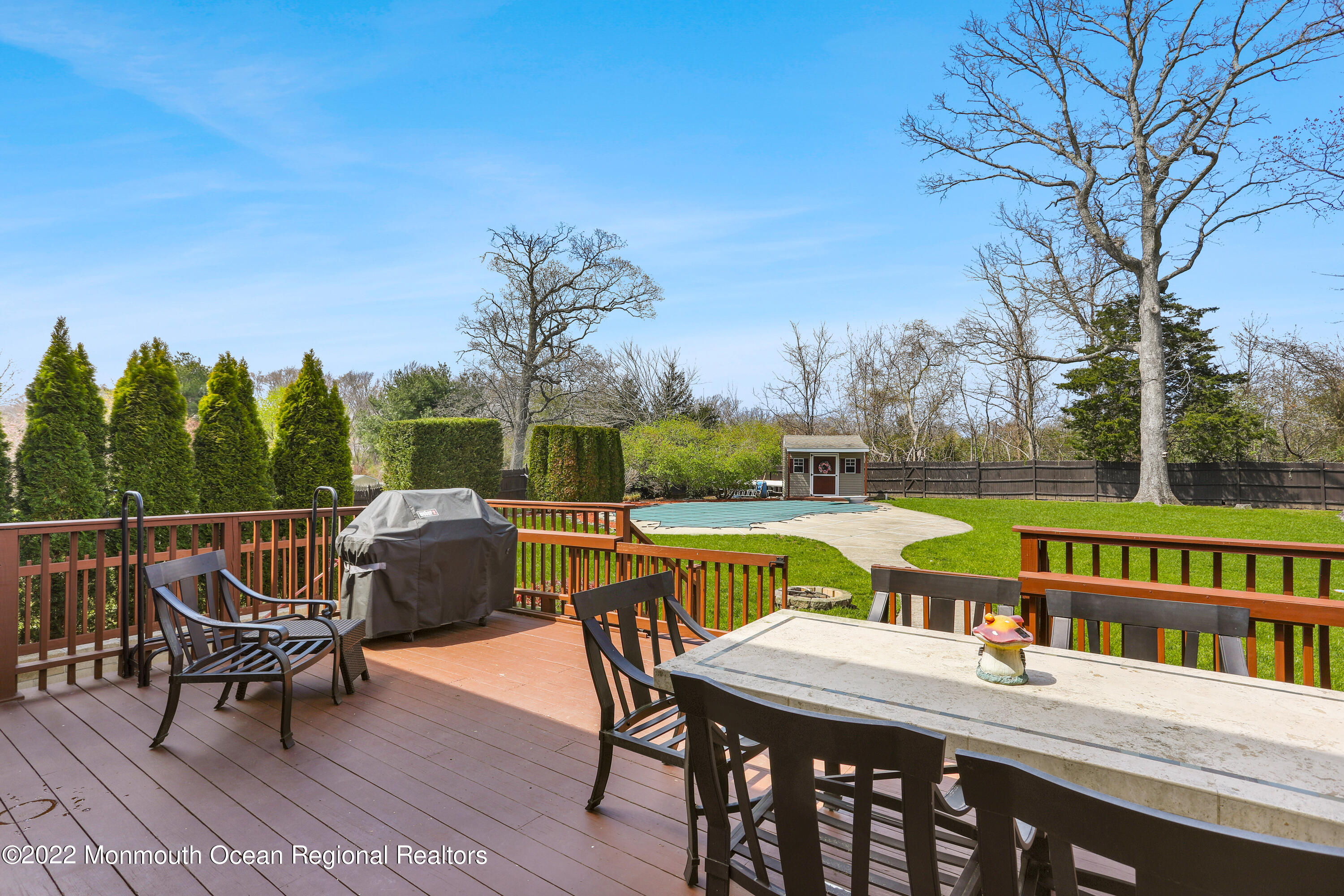 2606 Woolley Road Wall, NJ 07719 - Photo 28 of 47 a view of a patio with dining table and chairs with wooden floor and fence