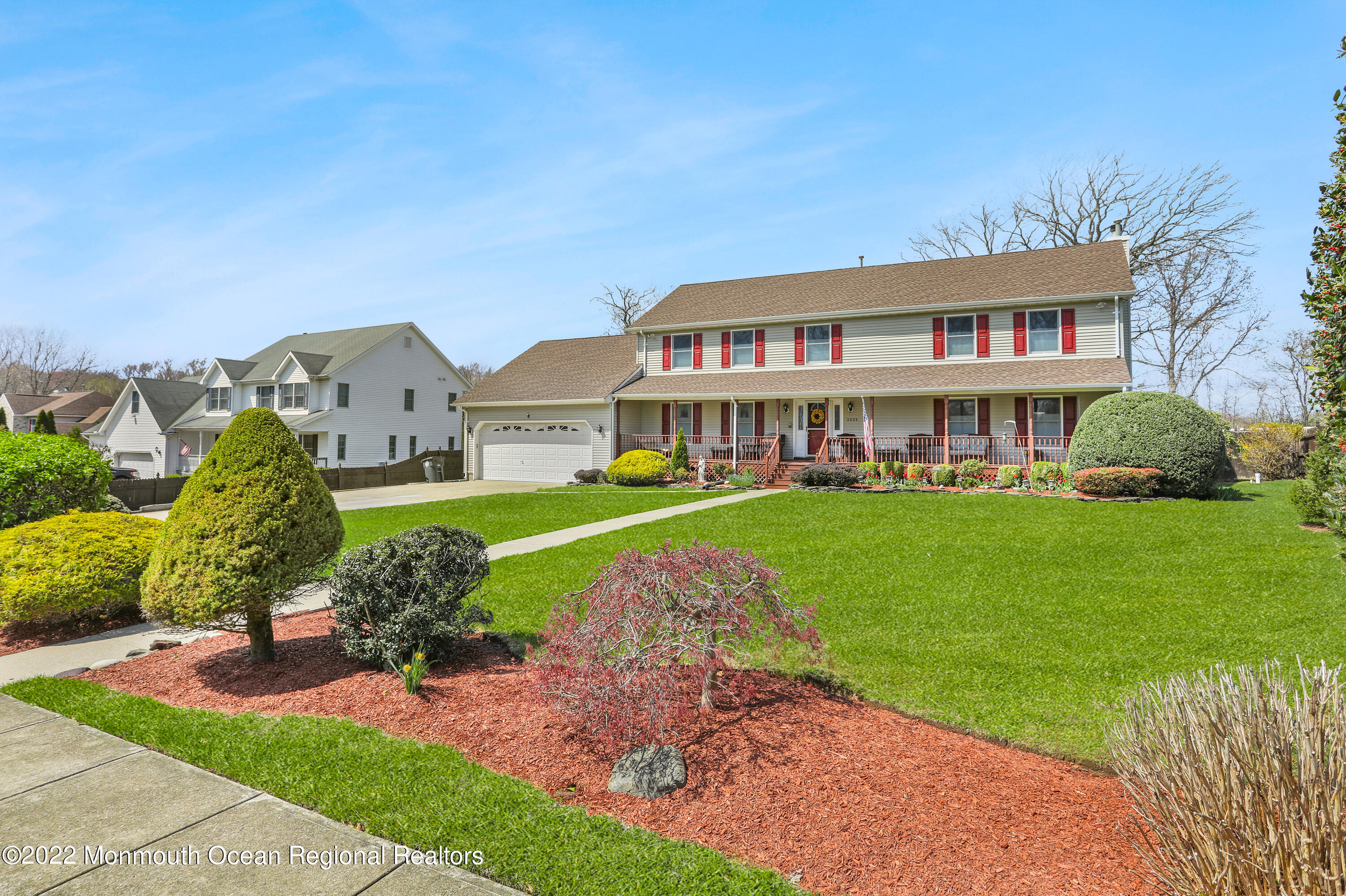 2606 Woolley Road Wall, NJ 07719 - Photo 3 of 47 a front view of a house with a garden and plants