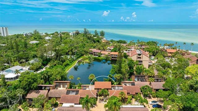 an aerial view of a house with a lake view