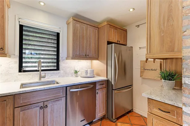 a kitchen with stainless steel appliances a refrigerator sink and cabinets