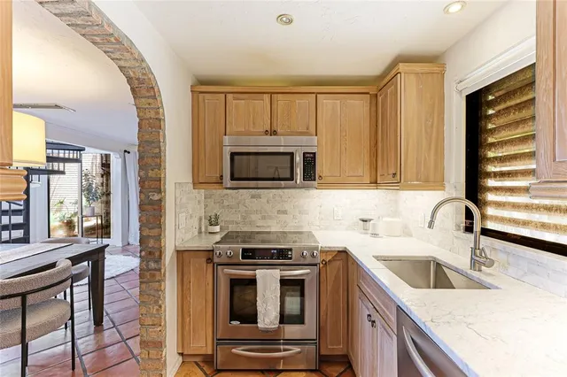 a kitchen with a sink stove and microwave