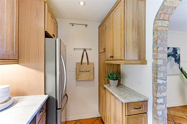 a kitchen with stainless steel appliances granite countertop a refrigerator and a stove