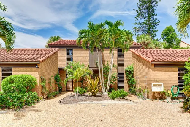 a view of a house with a yard and plants
