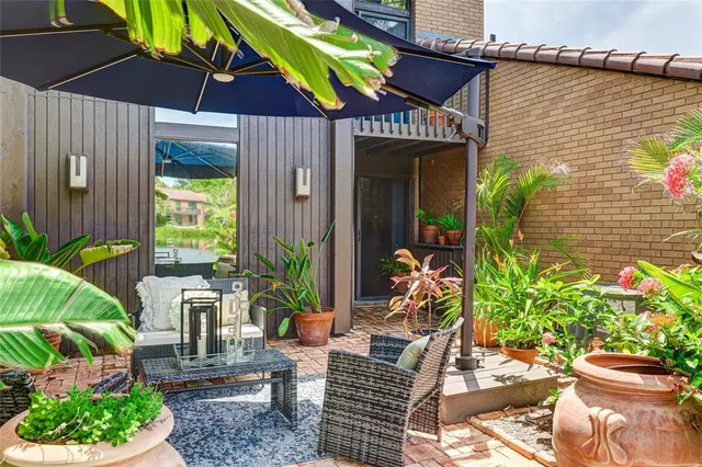 a view of a patio with couches under an umbrella