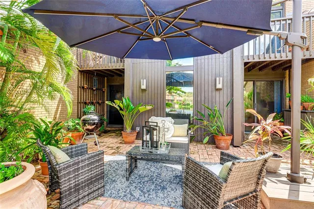 a view of an outdoor sitting area with furniture and umbrella