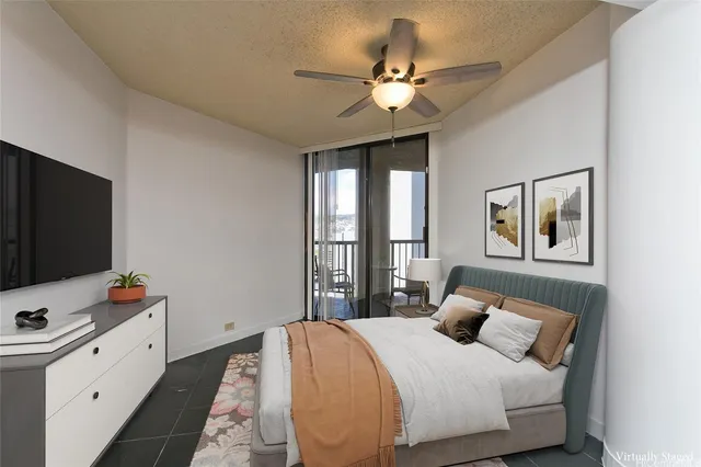 a bedroom with a large bed and a flat tv screen on dresser