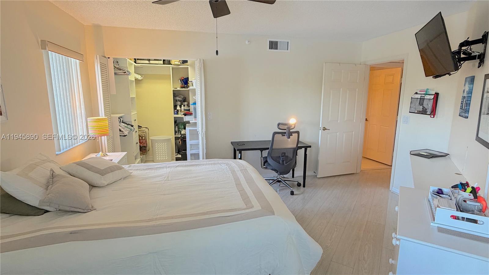 9539 Weldon Circle, Unit F207 Tamarac, FL 33321 - Photo 12 of 22 a bedroom with a bed and wooden floor