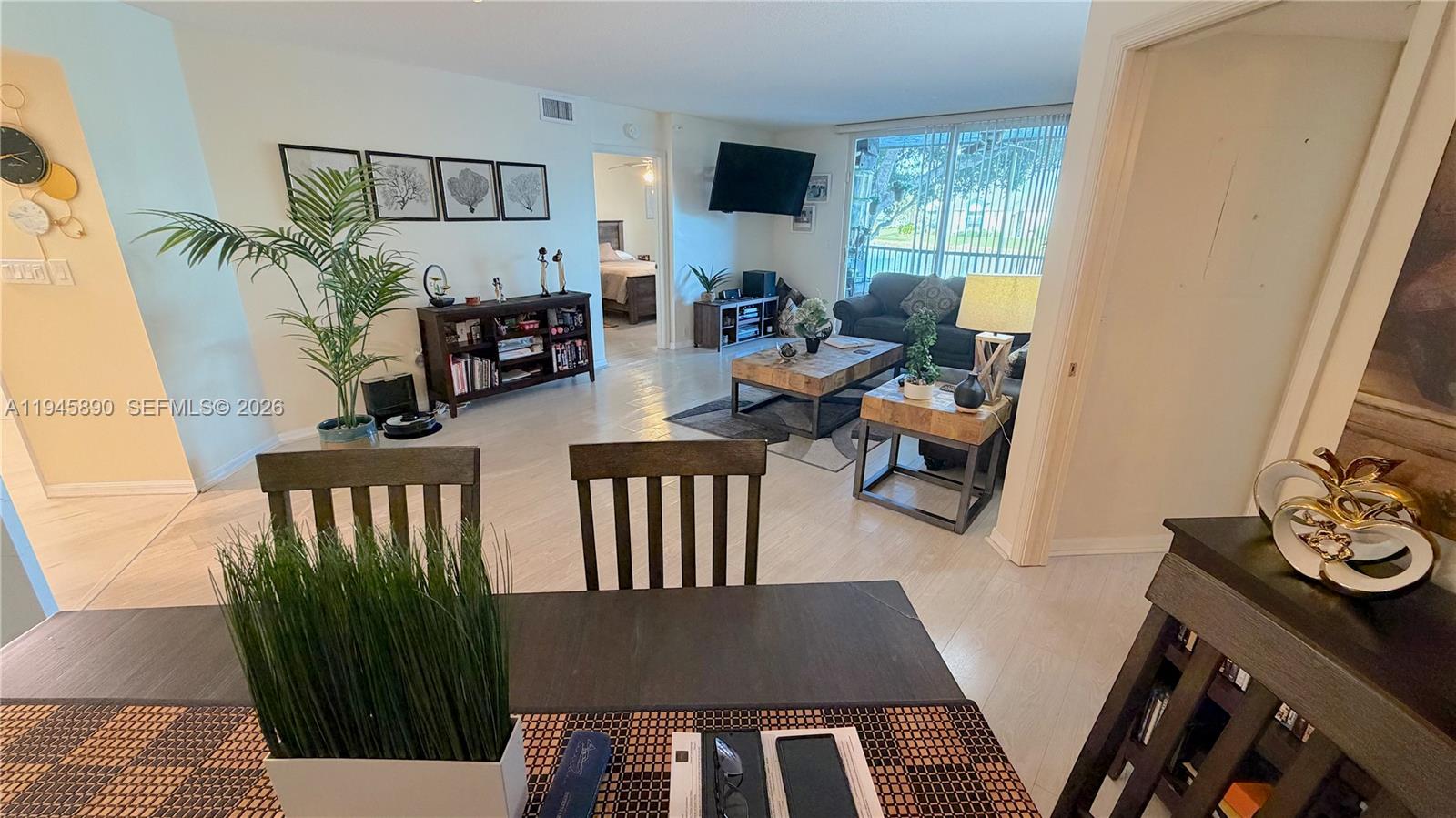 9539 Weldon Circle, Unit F207 Tamarac, FL 33321 - Photo 14 of 22 a living room with furniture fireplace and a flat screen tv