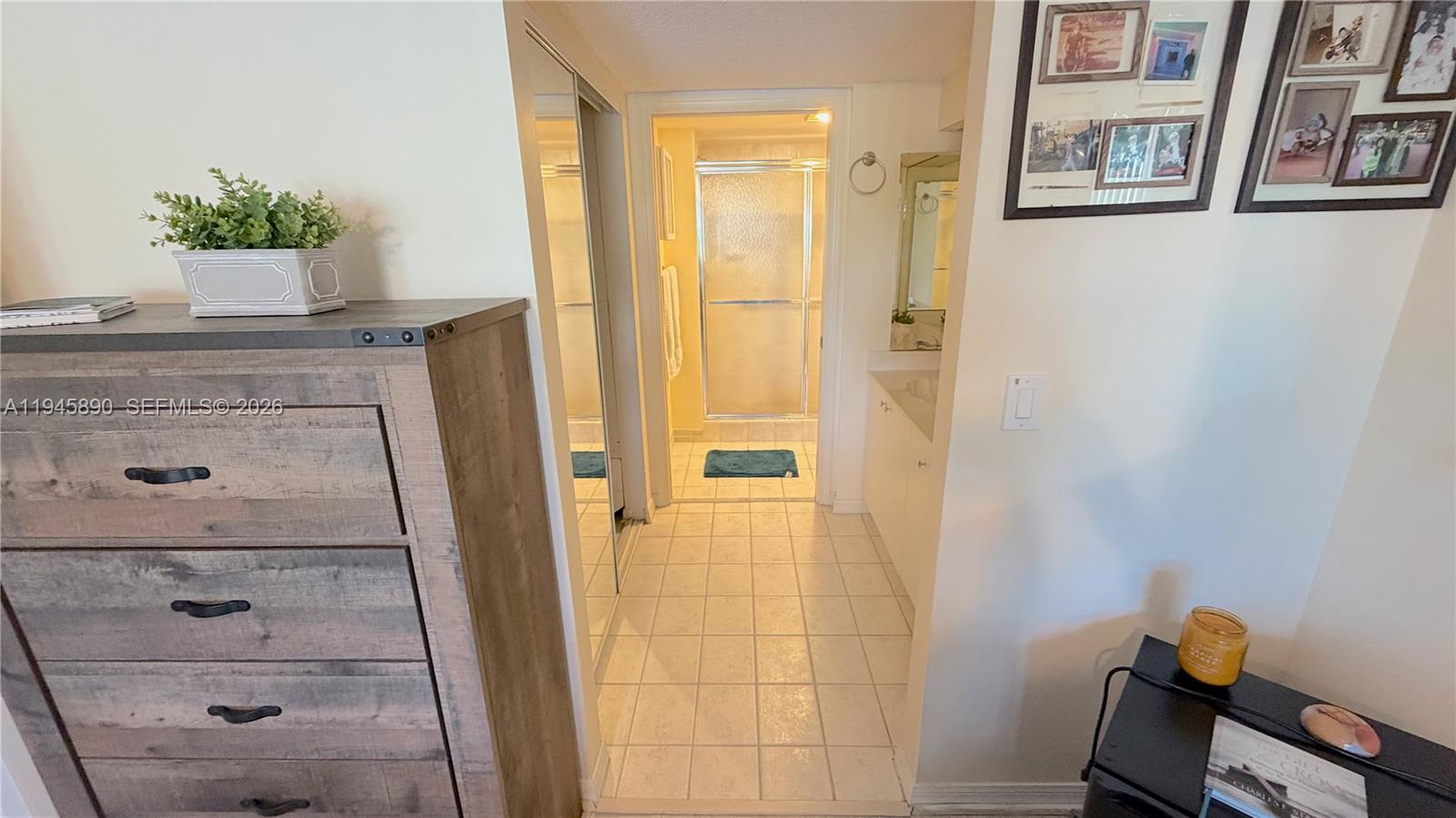 9539 Weldon Circle, Unit F207 Tamarac, FL 33321 - Photo 17 of 22 a bathroom with a tub shower and mirror