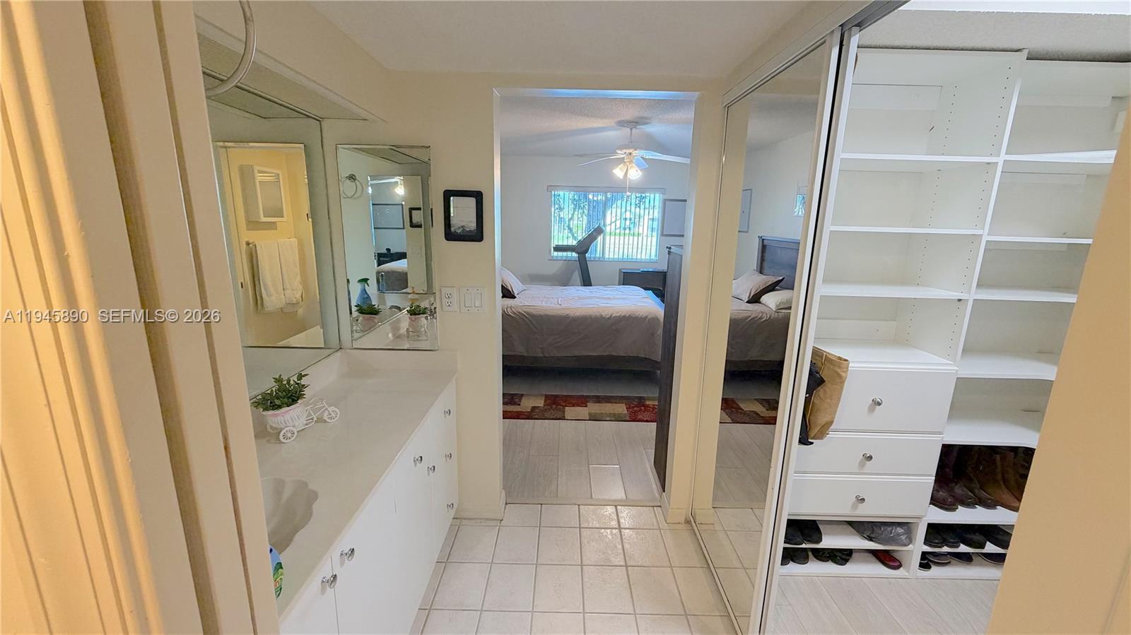 9539 Weldon Circle, Unit F207 Tamarac, FL 33321 - Photo 20 of 22 a hallway with white cabinets and wooden floor