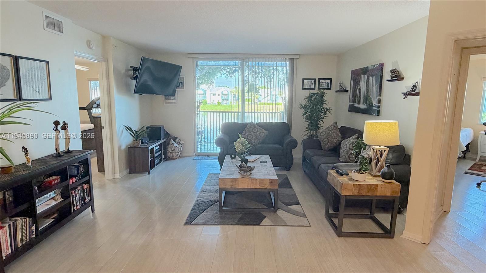 9539 Weldon Circle, Unit F207 Tamarac, FL 33321 - Photo 6 of 22 a living room with furniture and a window