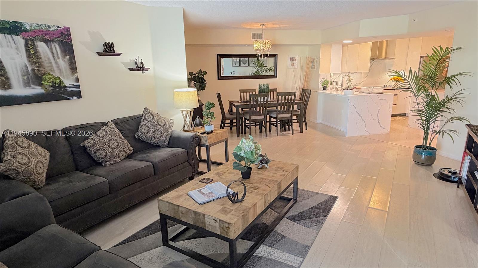 9539 Weldon Circle, Unit F207 Tamarac, FL 33321 - Photo 7 of 22 a living room with furniture and a table