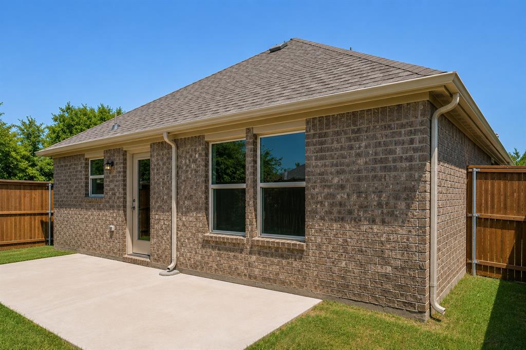 3344 Duncan Way Corinth, TX 76210 - Photo 27 of 38 Expansive concrete patio with a brick exterior, shingle roof, and a privacy fence