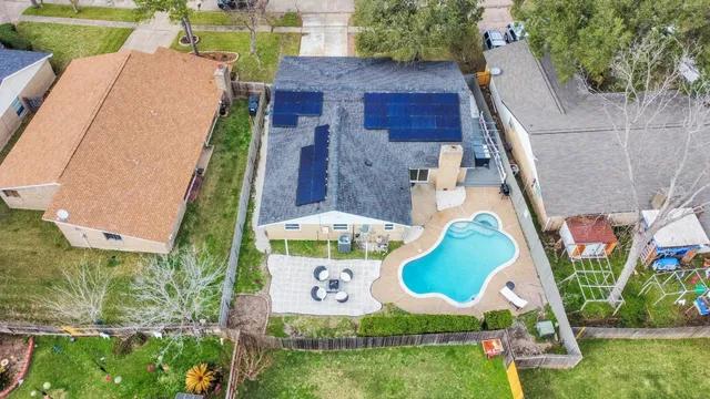 an aerial view of a house with a yard and potted plants