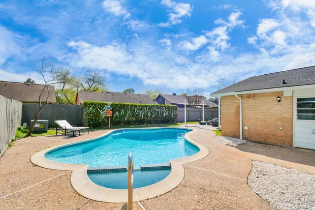a view of a swimming pool with a patio
