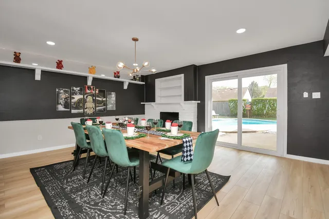 a dining room with furniture a rug and a chandelier
