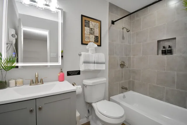 a bathroom with a sink toilet and shower