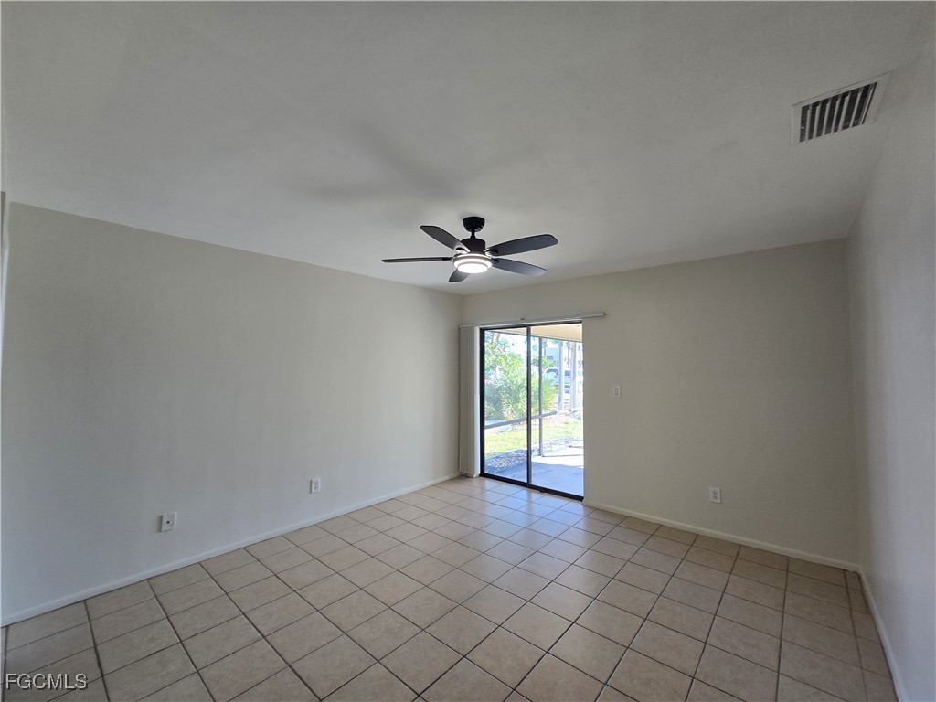 4803 Triton Court East, Unit 2 Cape Coral, FL 33904 - Photo 8 of 18 an empty room with windows and fan