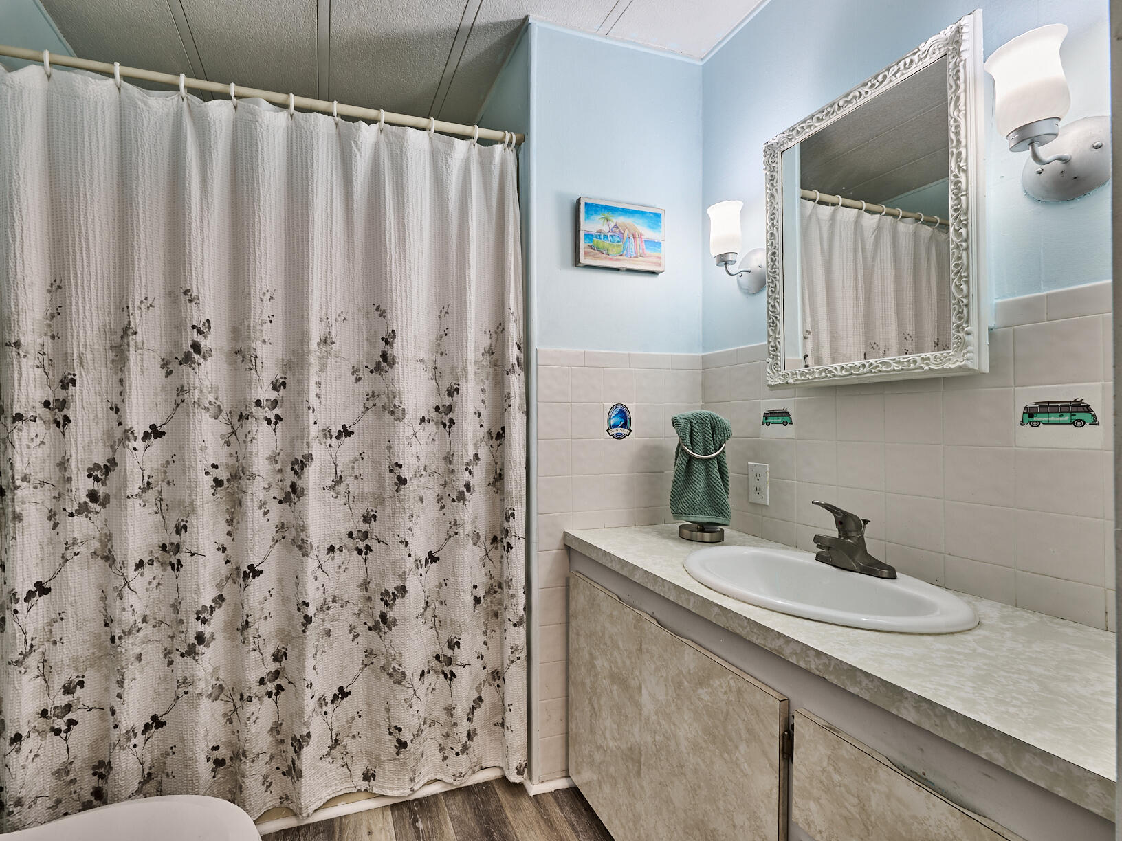 6977 Southeast Delegate Street Hobe Sound, FL 33455 - Photo 38 of 60 a bathroom with a sink and a mirror