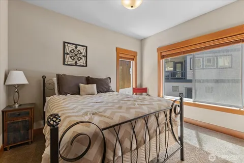 a bed sitting in a bedroom next to a window