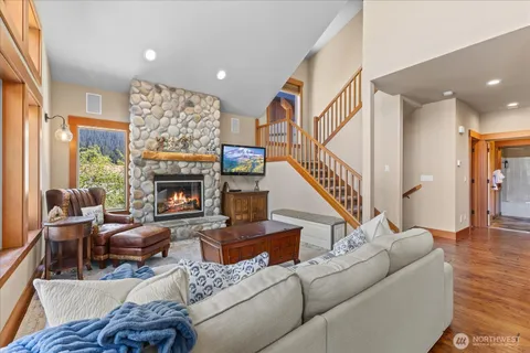 a living room with furniture a fireplace and a large window