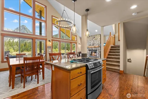 a kitchen that has a lot of cabinets a sink and a wooden floor