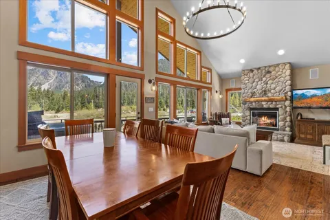 a dining room with furniture a fireplace and wooden floor