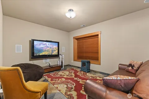 a bedroom with furniture and a flat screen tv
