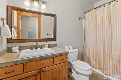 a bathroom with a toilet a sink and a mirror