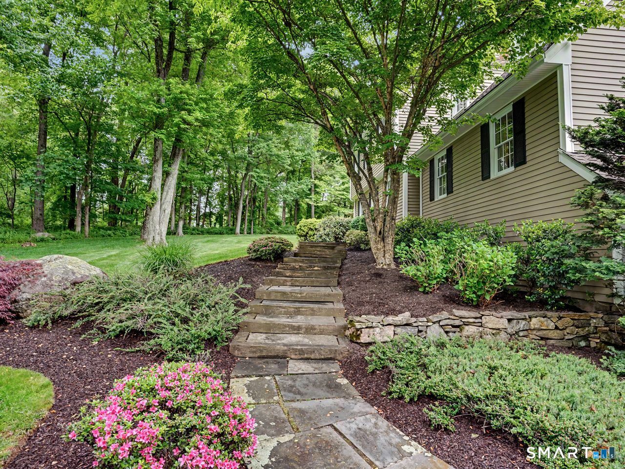 86 Fire Hill Road Redding, CT 06896 - Photo 8 of 36 a view of a garden with flowers and trees