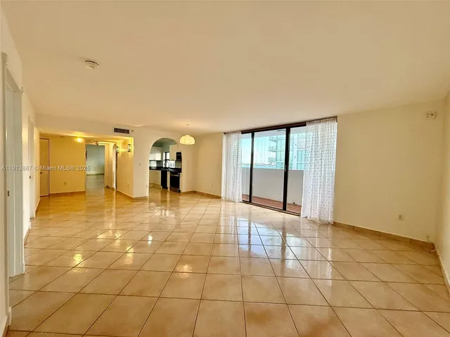 a view of an empty room with windows