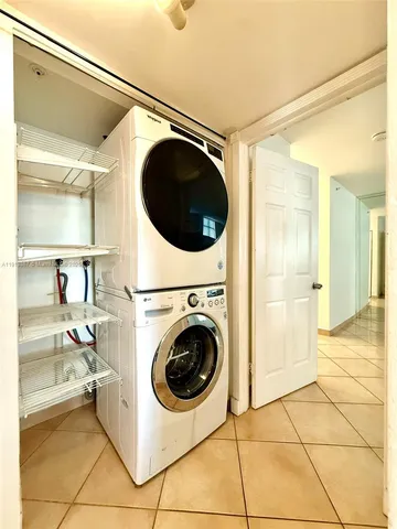 a view of empty room with wooden floor and window