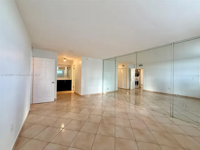 a room with a dresser and a large window
