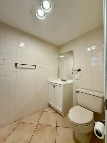 a bathroom with a toilet sink and a mirror